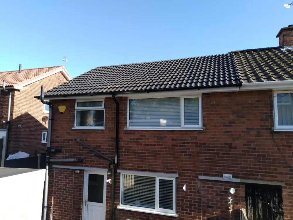 A finished roof and guttering from the back